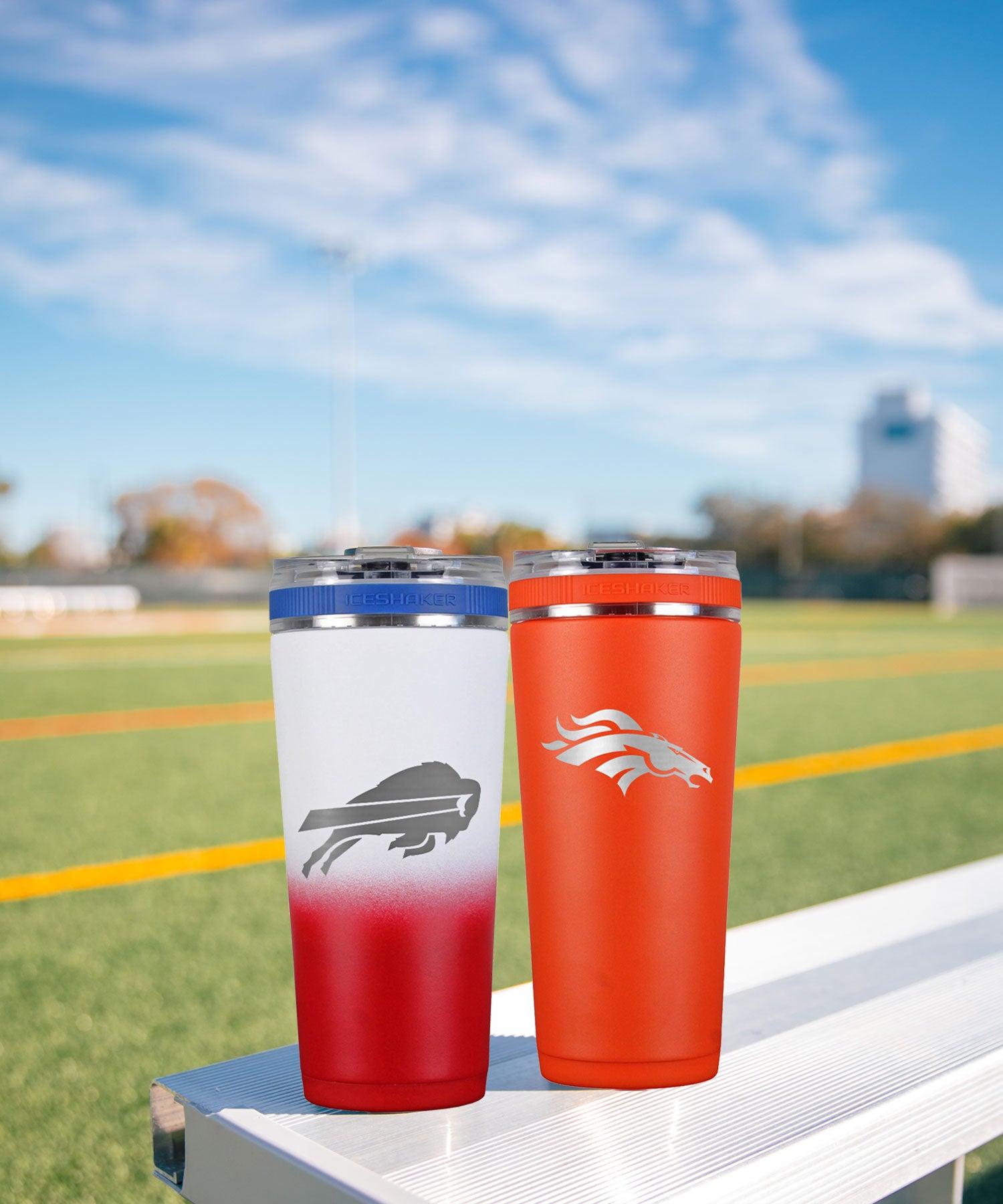 2 NFL Flex Bottles engraved with NFL team logos sitting on a bleacher in front of a football field.